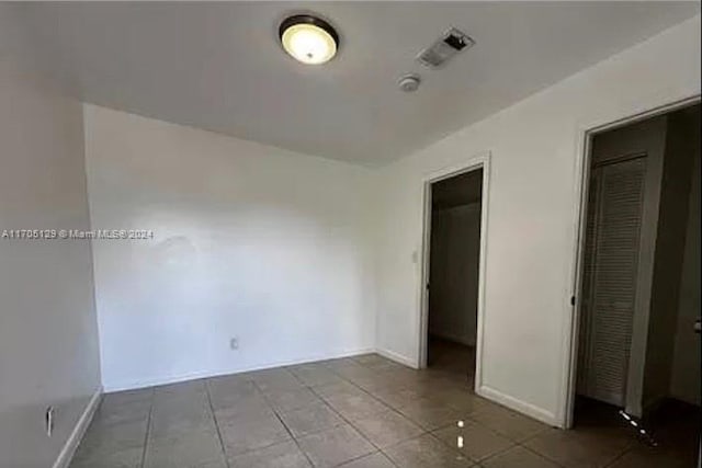 unfurnished bedroom with tile patterned floors