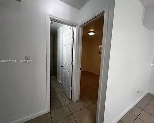 hallway with light tile patterned floors