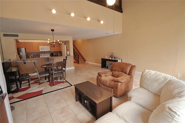 living room with light tile patterned flooring and a chandelier