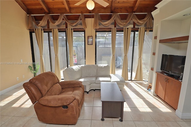 tiled living room featuring ceiling fan, beamed ceiling, and wood ceiling