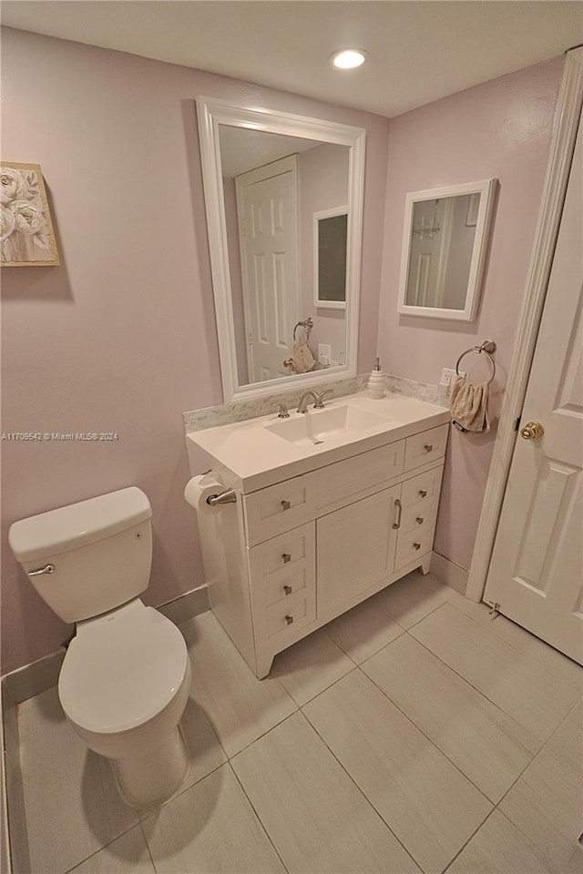 bathroom with tile patterned floors, vanity, and toilet