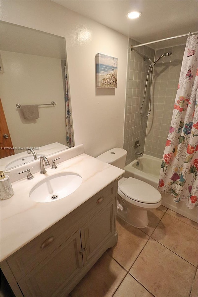 full bathroom featuring tile patterned floors, vanity, toilet, and shower / bathtub combination with curtain