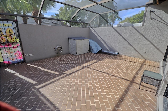 view of patio featuring glass enclosure