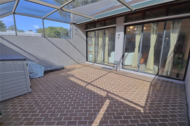 view of patio with glass enclosure