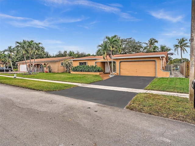 ranch-style home featuring a garage and a front lawn