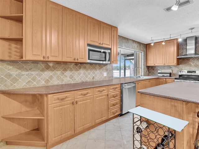 8910 NW 7th Ct, Pembroke Pines, FL 33024 - kitchen with open shelves, appliances with stainless steel finishes, wall chimney exhaust hood, track lighting, and tasteful backsplash