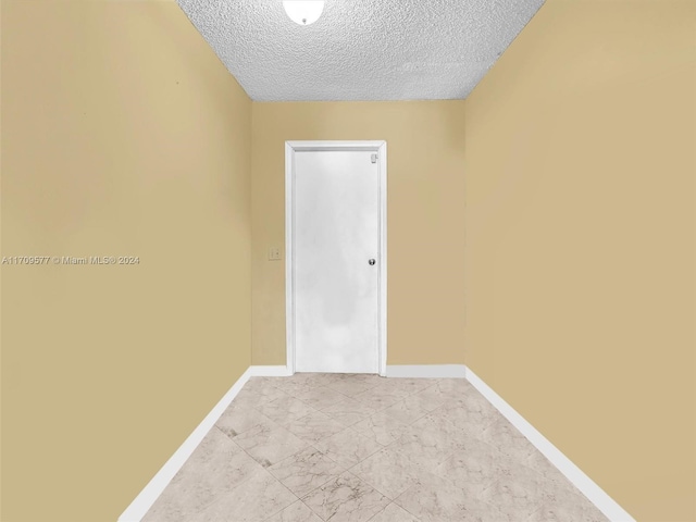 8910 NW 7th Ct, Pembroke Pines, FL 33024 - spare room featuring a textured ceiling and light marble finish flooring