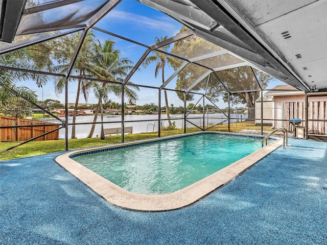 view of pool featuring glass enclosure and a water view