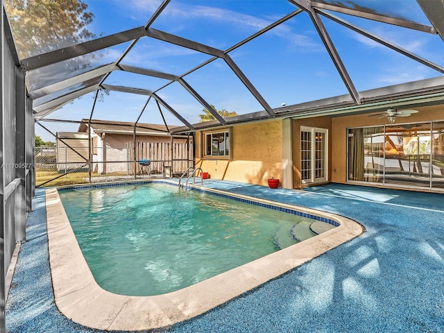 view of swimming pool featuring a patio area, ceiling fan, and a lanai