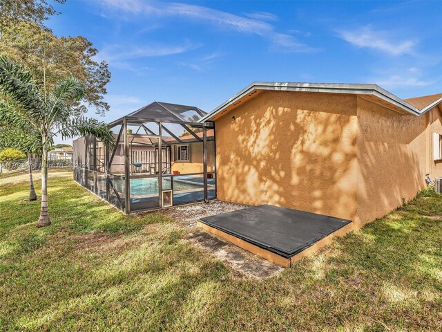 8910 NW 7th Ct, Pembroke Pines, FL 33024 - back of property with stucco siding, an outdoor pool, a lawn, and glass enclosure