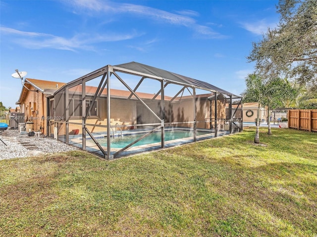 view of swimming pool featuring a lawn and glass enclosure