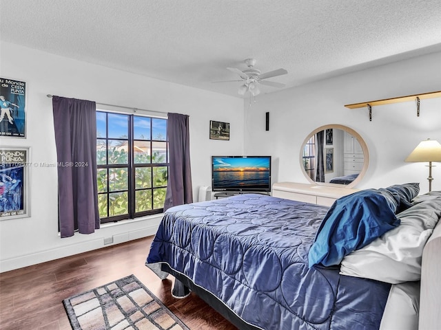 bedroom featuring ceiling fan, a textured ceiling, and hardwood / wood-style flooring