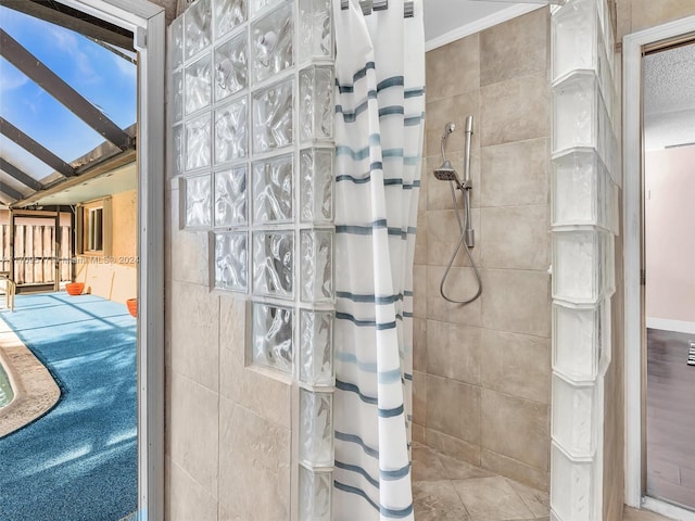 bathroom with tile patterned floors, curtained shower, and lofted ceiling