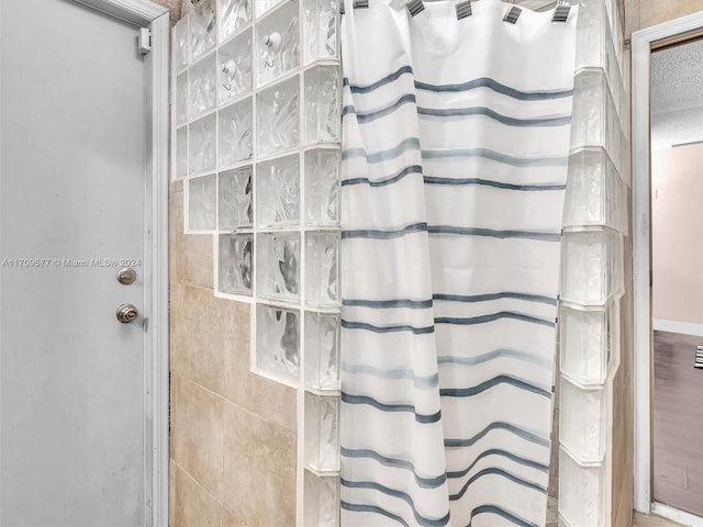 bathroom with hardwood / wood-style floors and curtained shower