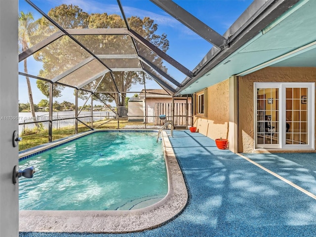 view of swimming pool featuring a lanai