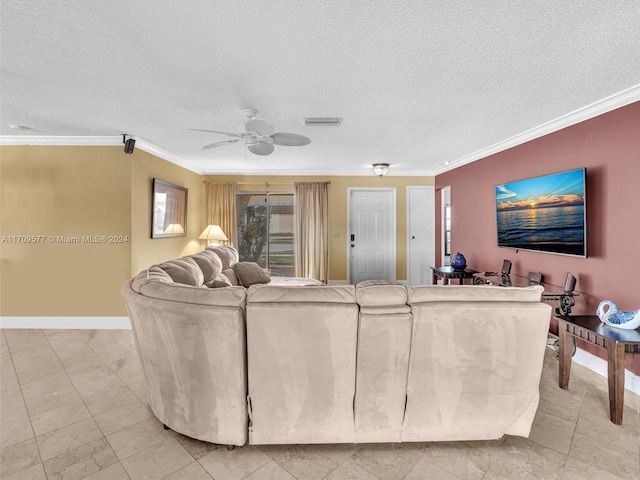 living room featuring ceiling fan, a textured ceiling, and ornamental molding