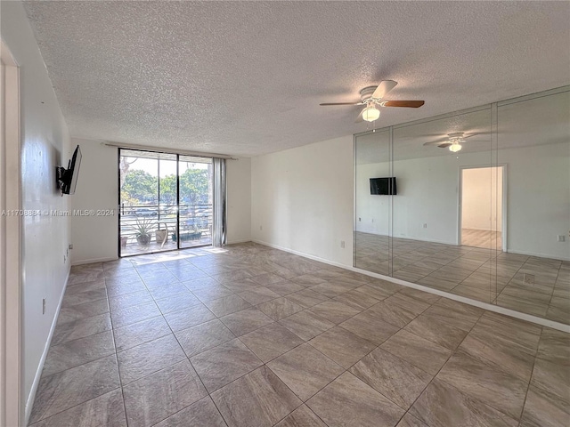 spare room with ceiling fan and a textured ceiling