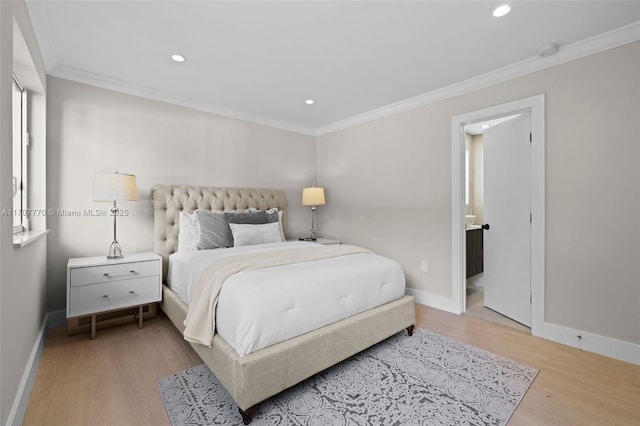 bedroom with connected bathroom, ornamental molding, and light hardwood / wood-style floors