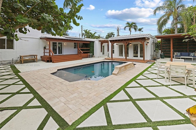 view of pool featuring outdoor lounge area and a patio