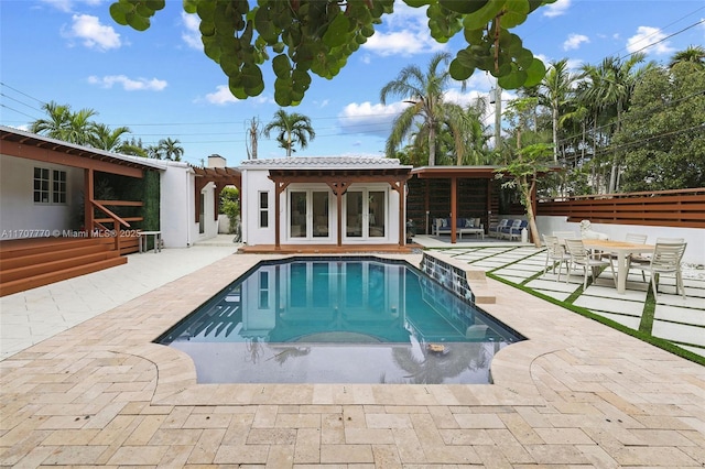 view of pool with a patio area and french doors