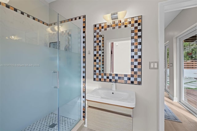 bathroom featuring vanity, a shower with shower door, and hardwood / wood-style floors