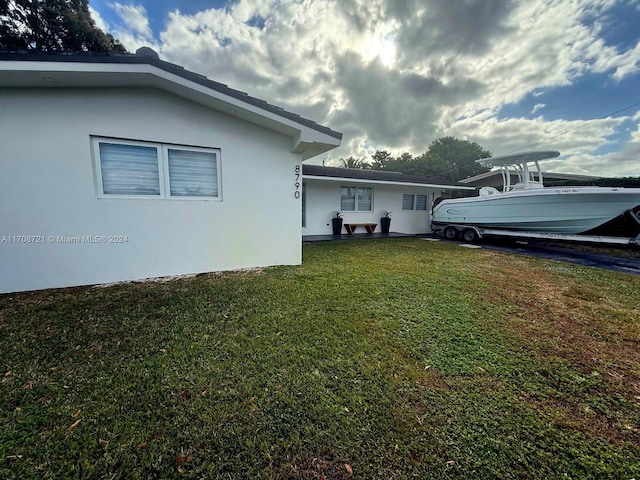 view of property exterior featuring a lawn