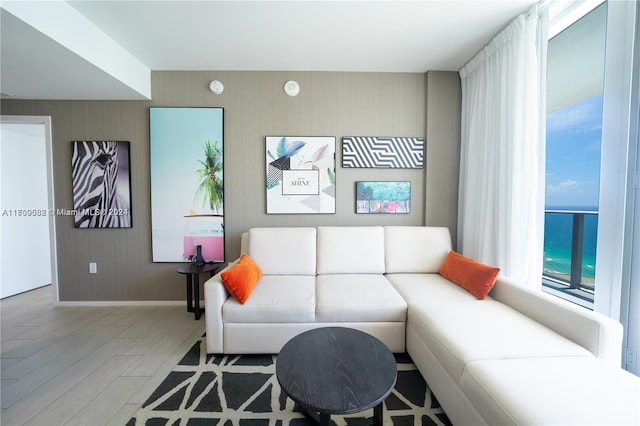 living room with a water view and light hardwood / wood-style flooring