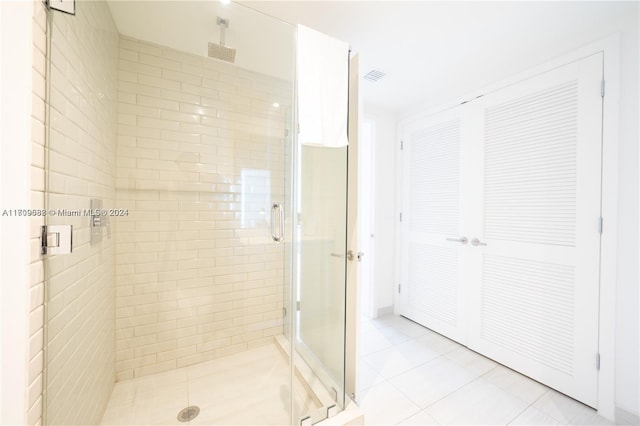 bathroom with tile patterned flooring and an enclosed shower