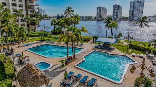 view of pool featuring a patio area and a water view