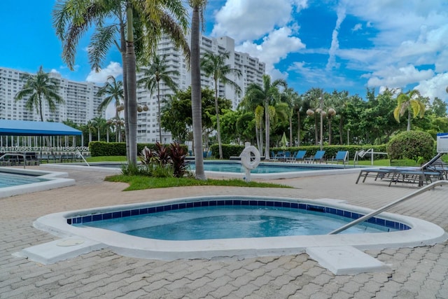 view of pool with a community hot tub