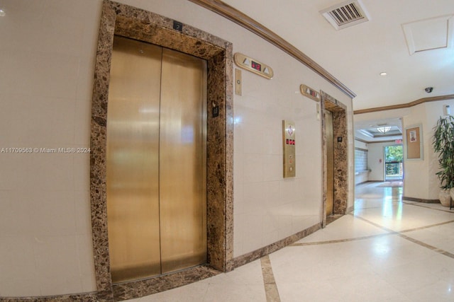 hall featuring elevator and crown molding