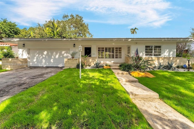 ranch-style house featuring a garage and a front yard