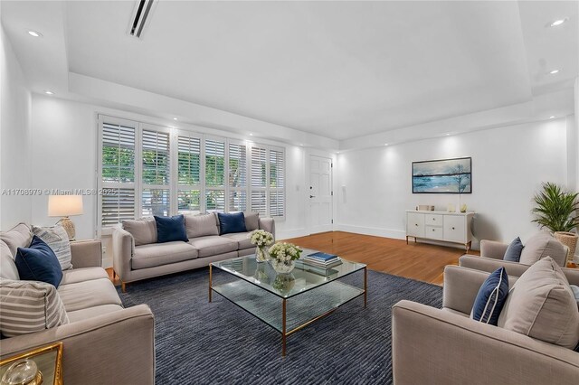 1431 Ancona Ave, Coral Gables, FL 33146 - living room featuring wood finished floors, recessed lighting, a raised ceiling, and baseboards