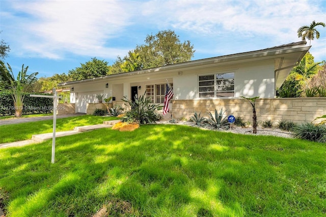 1431 Ancona Ave, Coral Gables, FL 33146 - ranch-style house with stucco siding and a front lawn