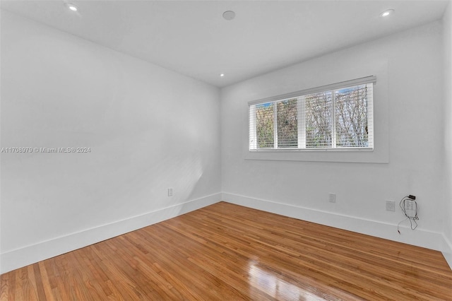 unfurnished room with hardwood / wood-style floors