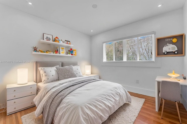 bedroom with recessed lighting, baseboards, and light wood-style floors