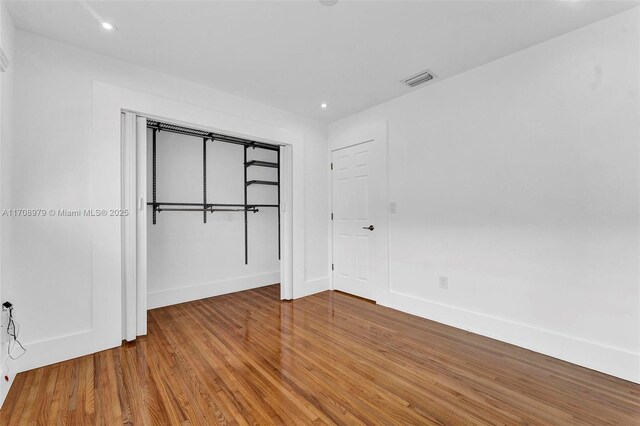 1431 Ancona Ave, Coral Gables, FL 33146 - unfurnished bedroom with wood finished floors, baseboards, recessed lighting, and a closet