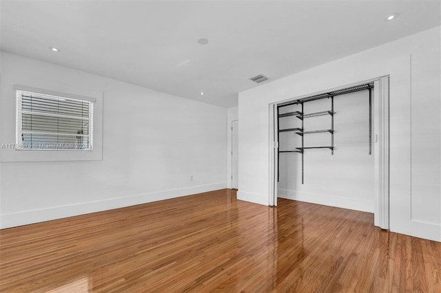 empty room with light hardwood / wood-style flooring