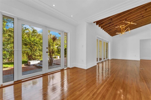 1431 Ancona Ave, Coral Gables, FL 33146 - unfurnished room with baseboards, wood finished floors, french doors, a chandelier, and recessed lighting