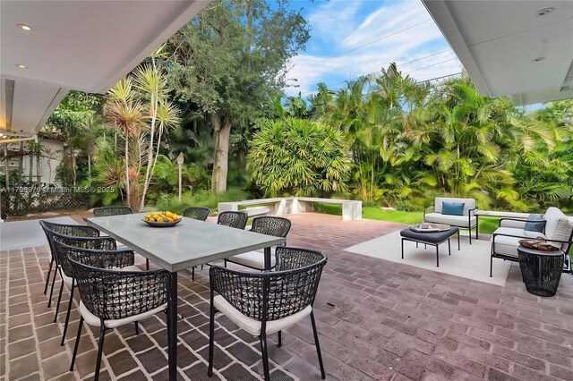 1431 Ancona Ave, Coral Gables, FL 33146 - view of patio / terrace with outdoor dining area and an outdoor living space with a fire pit