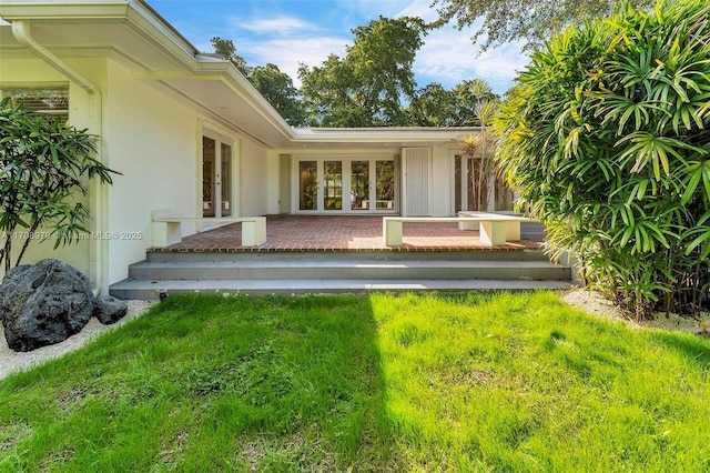 1431 Ancona Ave, Coral Gables, FL 33146 - rear view of property with french doors and stucco siding