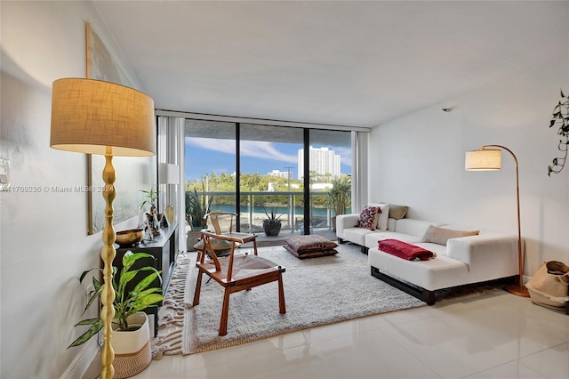 tiled living room featuring a water view and expansive windows