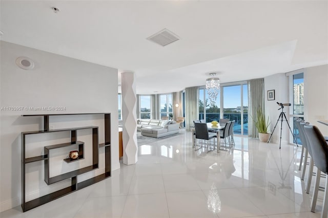 living room with light tile patterned floors and a chandelier