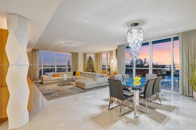 tiled dining area featuring plenty of natural light, expansive windows, and a notable chandelier