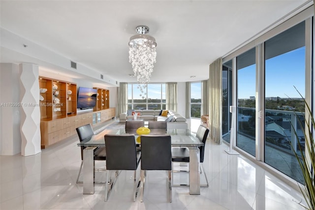 dining space featuring light tile patterned floors, floor to ceiling windows, and a notable chandelier