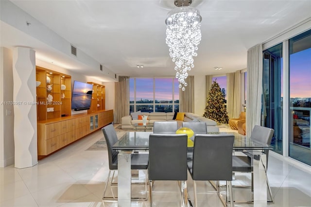 tiled dining area featuring an inviting chandelier