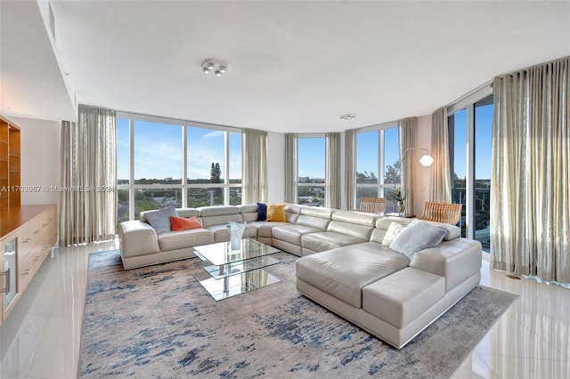 tiled living room with floor to ceiling windows and a wealth of natural light