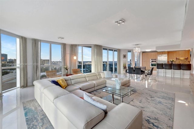 tiled living room featuring floor to ceiling windows