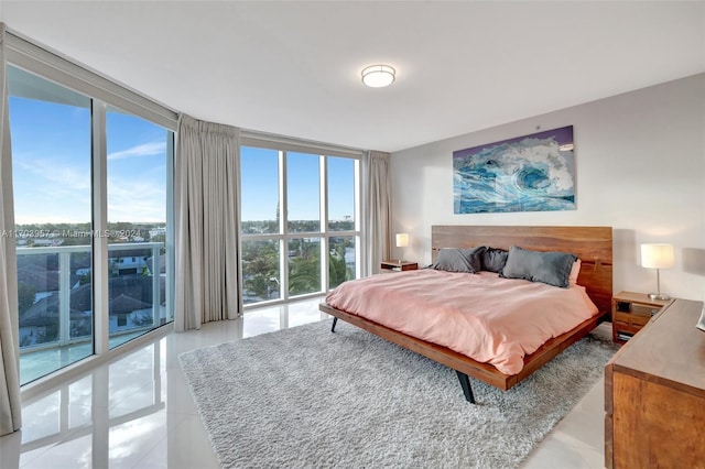 bedroom featuring light tile patterned floors and floor to ceiling windows