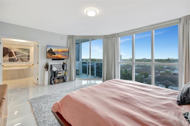 bedroom featuring tile patterned floors and ensuite bath